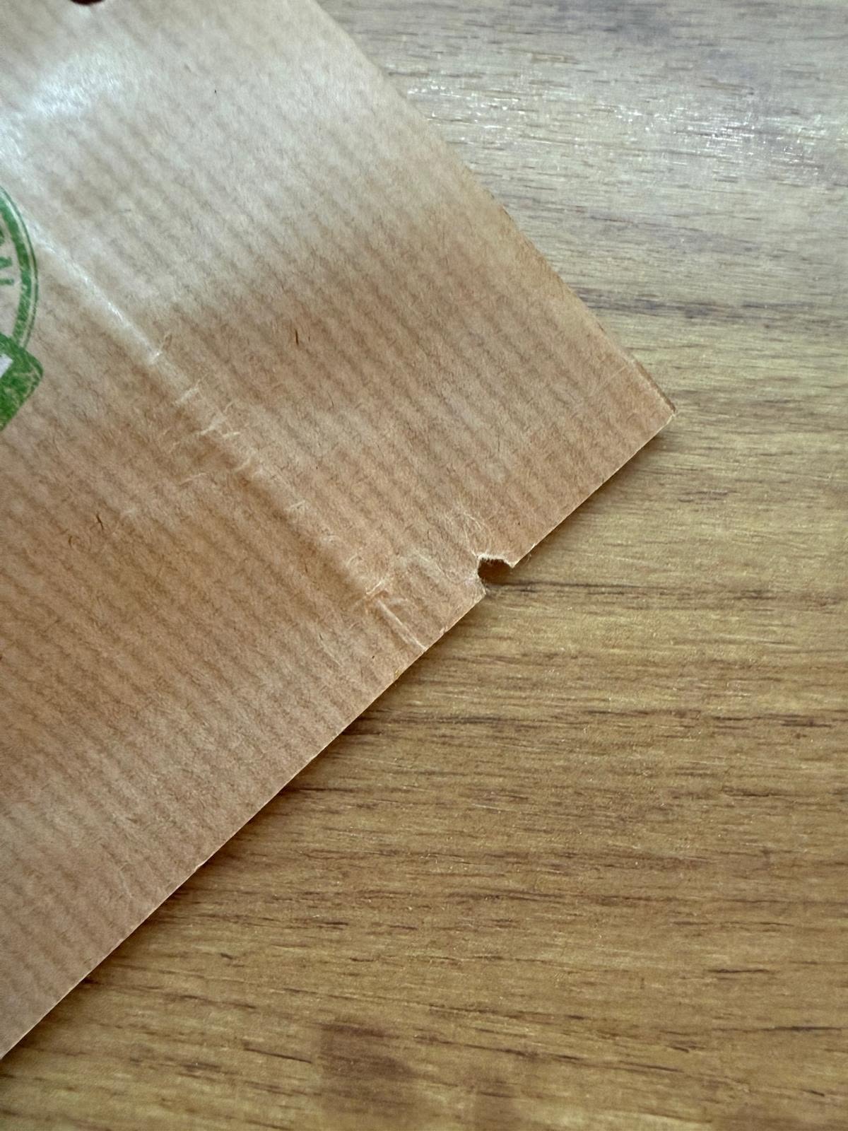 Tear notch on a kraft coffee bag for controlled opening without scissors